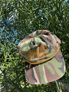 Vintage camo print trucker hat with snap back adjustable closure. Some signs of aging but no major flaws to note. One size fits most Brown Military Trucker Hat, Brown Military Style Trucker Hat, Military Style Adjustable 5-panel Trucker Hat, Adjustable Military Style 5-panel Trucker Hat, Military Style Adjustable Snapback Trucker Hat, Adjustable Military 5-panel Snapback Hat, Adjustable Military Style 5-panel Snapback Hat, Adjustable Camouflage Trucker Hat, Camouflage Trucker Baseball Cap With Flat Bill