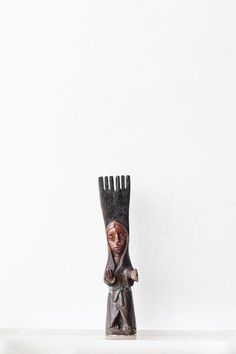 a sculpture of a woman holding a comb