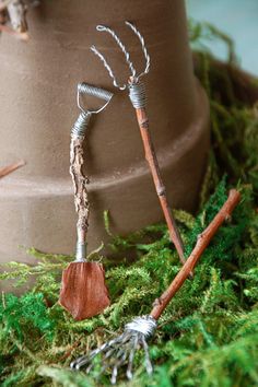 a close up of a planter with plants growing out of it and wire wrapped around the top