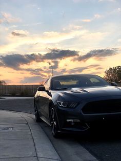 a black car parked on the side of a road