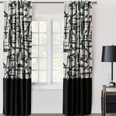 a black and white curtain hanging in front of a window