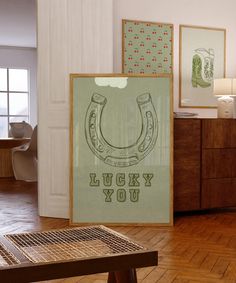 there is a poster on the floor in this room that says lucky you and an image of a horseshoe