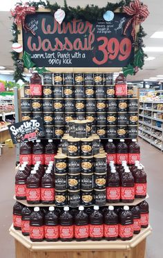 a display in a grocery store filled with lots of bottles of syrup and ketchup