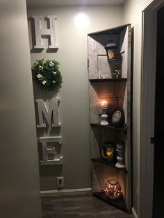 an open door leading into a room with shelves and decorations on the wall above it