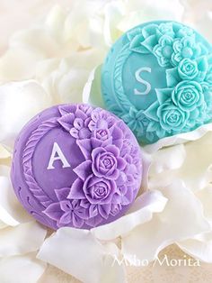 two soap balls with flowers on them sitting next to each other