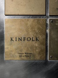 three metal plaques with the words kinfolk on them