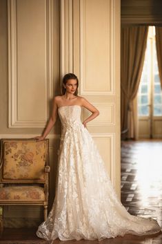 a woman in a wedding dress leaning against a wall