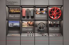 a display case with different types of items on the wall, including steering wheel and gauges