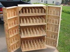 an open wooden box sitting on the side of a road