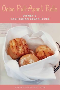 some food is in a white basket on a table with text overlay that reads onion pull apart rolls disney's yachsman steakhouse