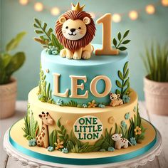 a blue and yellow cake with a lion on top that says leo one little lion