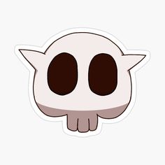 a white sticker with black eyes and horns on it's head, in the shape of a skull