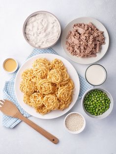 the meal is ready to be eaten on the table, including noodles and meats