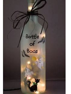 a bottle with some lights in it and a black cat on the bottom that says bottle of boos