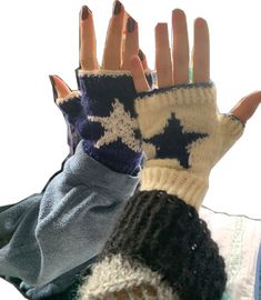 two hands wearing mittens with stars on them