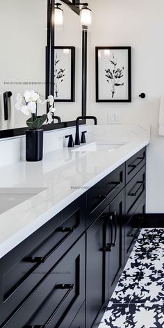 a black and white bathroom with double sinks