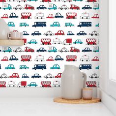 a wallpaper with cars and buses on it in a room that has white walls