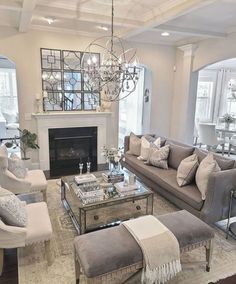 a living room filled with furniture and a fire place in the middle of a room