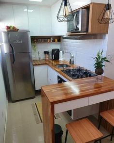 a kitchen with a stove top oven sitting next to a refrigerator freezer and counter