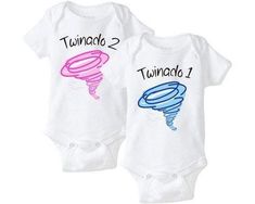 two white onesuits with pink and blue designs that say tumbach 2, tornado 1