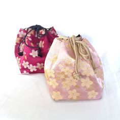 Drawstring bag with a cute cherry blossom pattern. Two colors available. It can be used both with yukata, and an accessory to a Western-style outfit, or a costume.  The lining is black. It has a rigid bottom. Size H16x13x13cm. String length 30cm. Please note, this is a vintage item.  The vine red one has small spot damage near the bottom. Please check the photos for the details. The item is in a good condition, but there might be some minuscule imperfections, such as a spot of discoloration, a s Spring Gift Pouch Bucket Bag, Cute Cherry Blossom, Cherry Blossom Pattern, Sakura Flowers, Western Style Outfits, Top Handle Bags, Japanese Silk, String Bag, Western Style