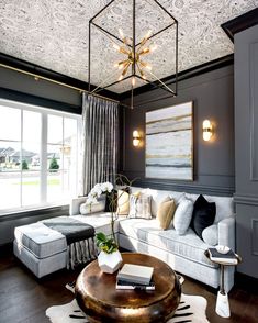 a living room filled with furniture and a chandelier