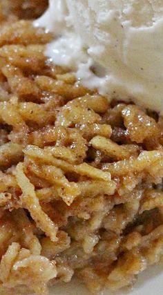 a close up of a plate of food with some ice cream on top and another dessert in the background