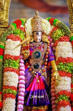 an idol is displayed in front of flowers