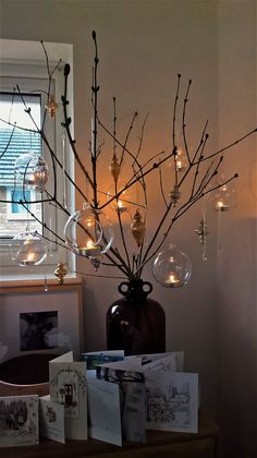 a vase filled with glass balls and branches