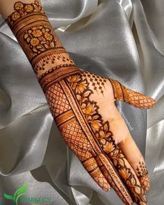 a hand with henna tattoos on it