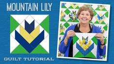 a woman holding up a quilt with the words mountain lily on it and an image of a