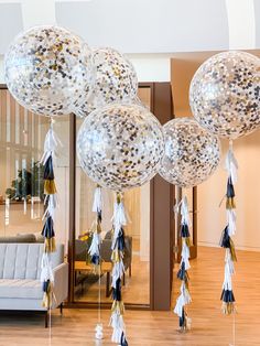 balloons with tassels and streamers are hanging from the ceiling