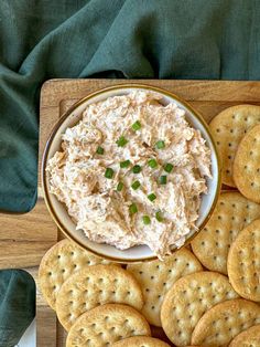 crackers and dip in a bowl on a wooden tray