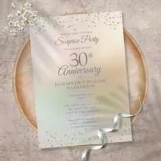 an elegant 30th birthday party card with silver confetti and ribbon on a plate