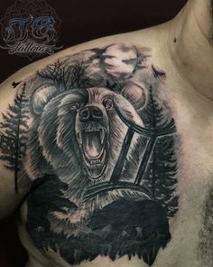 a man with a bear tattoo on his chest