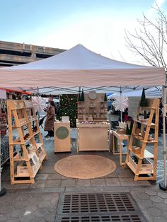 a group of wooden shelves under a white tent