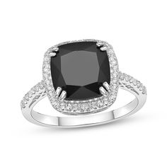 Big and bold, this gemstone ring makes a fashion statement. Created in sterling silver, this ring showcases a faceted cushion-cut black onyx wrapped in a frame of round white lab-created sapphires. More lab-created sapphires decorate the ring’s slender shank for a sparkling finish. Gold Layered Bracelets, Pearl Diamond Jewelry, Black Cushion, Cross Jewelry Necklace, Fan Jewelry, Cushion Halo, Tennis Bracelet Diamond, Ring Style, Sapphire Stone