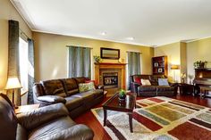 a living room filled with furniture and a fire place in the middle of a room