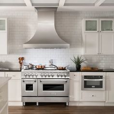 a stove top oven sitting inside of a kitchen next to an oven and countertop