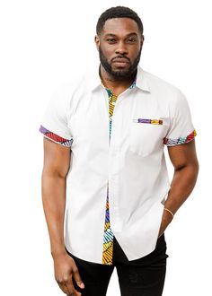 PRICES MAY VARY. VIBRANT AFRICAN PRINT DESIGN: Stand out from the crowd with the Salim Men's African Print Color-Blocked Shirt in White, featuring eye-catching Abstract Lines trim on the sleeve band, inner placket, collar, and welt pocket, adding a pop of color and style to your look. COMFORTABLE AND COOL: Crafted from 97% COTTON/3% LYCRA POPLIN Body, this short sleeve shirt offers a comfortable and breathable fit, ensuring you stay cool and stylish all day long, no matter the occasion. VERSATIL Latest African Men Fashion, Style Africain, African Shirts For Men, Color Block Shirts, African Clothing For Men, African Shirts, African Inspired Fashion, African Men Fashion, African Men