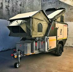 a man standing next to a truck with a tent on it