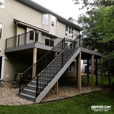 a house with a deck and stairs leading up to it