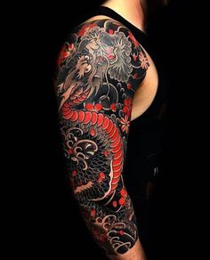 a man with a dragon tattoo on his arm and shoulder is standing in front of a black background