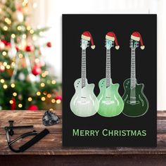 a christmas card with three guitars on it