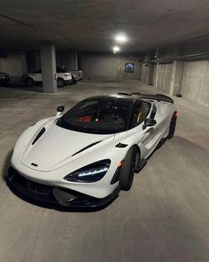 a white sports car parked in a parking garage