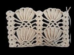 a crocheted doily with shells on it is shown in the shape of a square