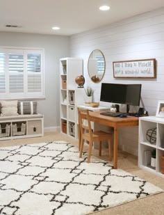 a computer desk sitting on top of a white rug