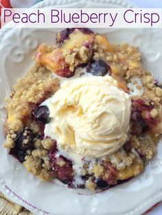 a close up of a plate of food with ice cream on it and the words peach blueberry crisp