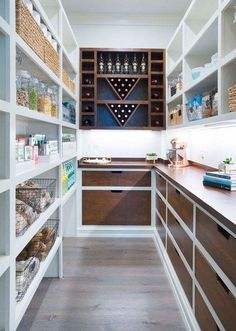 an organized pantry with lots of shelves and baskets