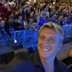 a man is smiling in front of an audience